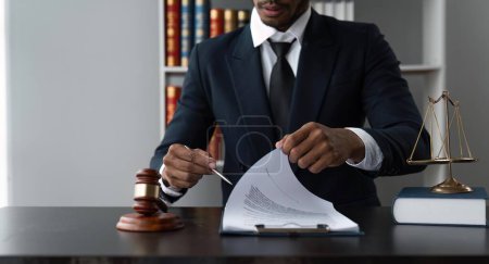 Photo for Male lawyer working at table in office. - Royalty Free Image