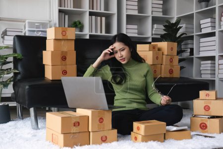 Photo for Young startup small business entrepreneur woman packing package post shipping box preparing delivery parcel , Online business, ecommerce and delivery concept. stressed headache. - Royalty Free Image