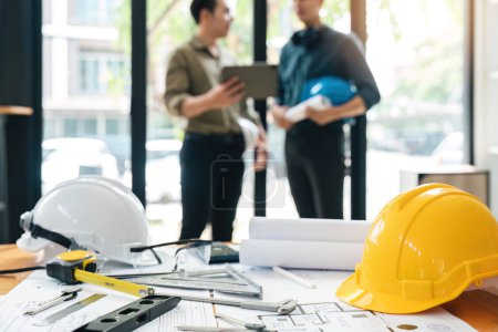 Photo for Engineer teams meeting working together holding worker helmets on construction site in modern city.Asian industry professional team. - Royalty Free Image