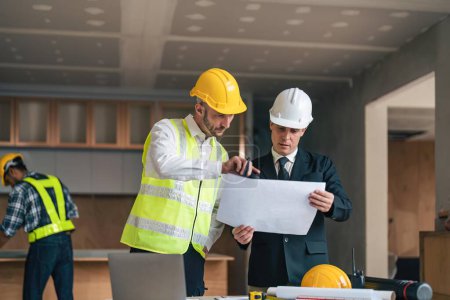 Photo for Professional construction engineers team using blueprint of project plan brainstorming and working together at construction building, Architecture and building construction concept. - Royalty Free Image