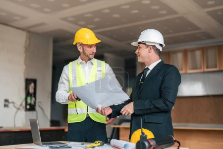 Foto de Professional construction engineers team using blueprint of project plan brainstorming and working together at construction building, Architecture and building construction concept. - Imagen libre de derechos