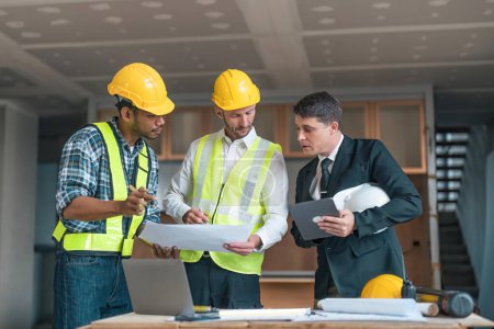 Professional construction engineers team using blueprint of project plan brainstorming and working together at construction building, Architecture and building construction concept. Stickers 658399302