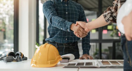 Photo for Engineer and contractor shaking hands success of the project work together. - Royalty Free Image