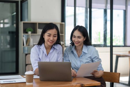 Téléchargez les photos : Heureux deux belle jeune femme d'affaires asiatique debout discuter travailler ensemble au bureau. - en image libre de droit