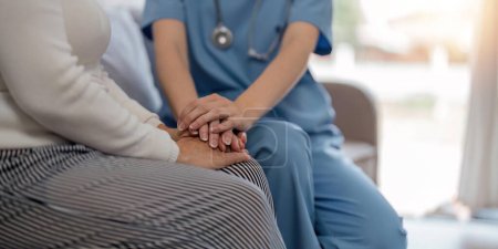 Photo for Doctor giving hope. Close up shot of young female physician leaning forward to smiling elderly lady patient holding her hand in palms. Woman caretaker in white coat supporting encouraging old person. - Royalty Free Image