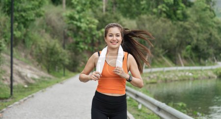 Photo for Jogging woman running in park on beautiful day off. Sport fitness model of asian ethnicity training outdoor for marathon. - Royalty Free Image
