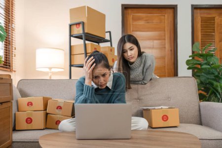 Photo for Asian woman friends feeling frustrated stressed after check sale order. Young attractive two female working and checking e-commerce shipping for online retail at home. - Royalty Free Image