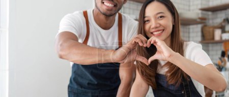 Photo for Love, a couple and heart hand sign man and woman together. Marriage, heart hands and relationship with support and trust in kitchen. - Royalty Free Image