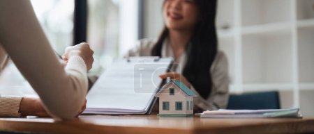 Photo for Real estate agent to his discussion and consult about house contracts client after signing contract, concept for real estate, moving home or renting property. - Royalty Free Image