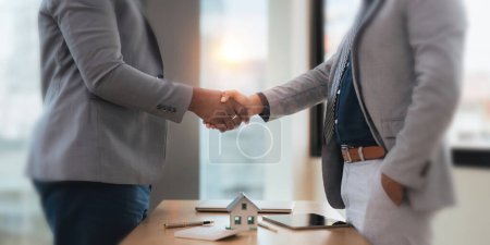 Photo for Close up of African American business man and Indian man shaking hands while at the office with diversity. - Royalty Free Image