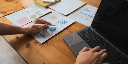 Photo for Young business man looking at computer monitor, analyzing project statistics, marketing research results or statistics data, developing marketing strategy, working at office. - Royalty Free Image