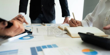 Photo for Business team analyzes financial business finance reports on laptop and graph documents during corporate meeting discussion showing successful teamwork, business meeting ideas. - Royalty Free Image