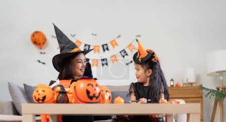 Photo for Happy family mother and child happy girl with Halloween at home together beautifully decorated. - Royalty Free Image