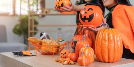 Photo for Halloween concept mom and daughter preparing to celebrate at home together beautifully decorated. - Royalty Free Image