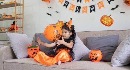 Photo for Cute little child girl with balloon. Happy family preparing for Halloween. - Royalty Free Image