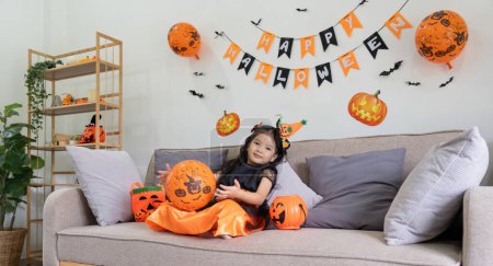 Photo for Cute little child girl with balloon. Happy family preparing for Halloween. - Royalty Free Image