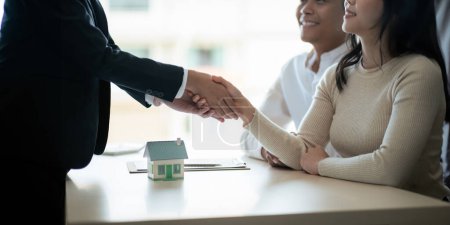 Photo for Real estate asian agent shakes hands with husband and wife customer finished contract after about housing insurance and investment loan. - Royalty Free Image