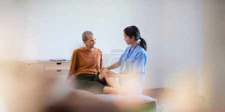 Photo for Physical therapist caregiver Asian and Caucasian senior women trust moving hand in rehabilitation. Physiotherapy healthcare, Medical caregiver consulting disabled elderly patient at home. - Royalty Free Image