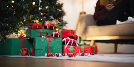 Foto de Fondo Árbol de Navidad y caja de regalo con decoraciones cerca de una chimenea con luces. - Imagen libre de derechos