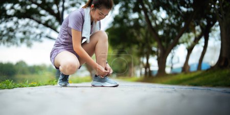 Photo for Young woman stretch during stretching exercise outdoors in the park. - Royalty Free Image