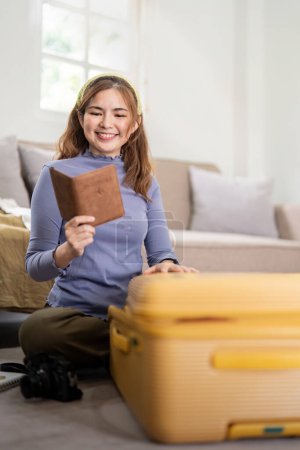 Photo for Woman packing suitcase for a new journey packing list for travel planning. prepare vacation. traveling. - Royalty Free Image