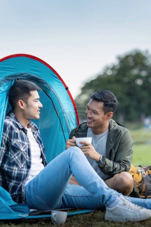 Photo for Happy Asian male gay couple on camping together in a forest. romantic vocation trip. lgbt concept. - Royalty Free Image