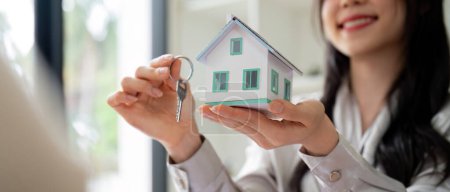 Téléchargez les photos : L'agent immobilier remet la propriété ou les clés d'habitation neuves à un client
. - en image libre de droit