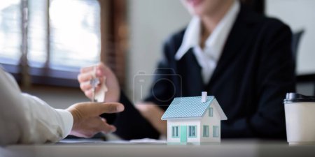 Photo for Customer meet and negotiation with real estate agents about renting, buying home, Real estate agent negotiate, talk about the terms of the home purchase agreement and asked customer to sign contract. - Royalty Free Image