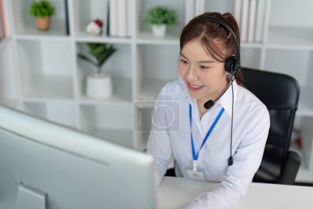 Photo for Call center friendly woman asian in office for customer service, technical support and advice, contact and communication with employee operator in help desk agency. - Royalty Free Image