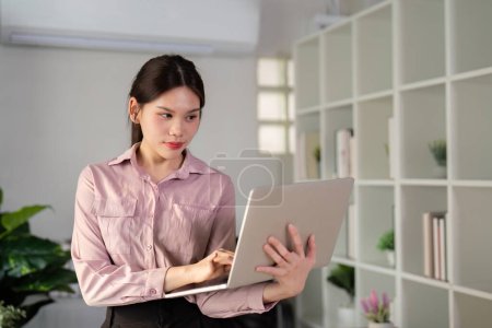 Businesswoman using laptop computer work from home in room. freelance, lifestyle concept.