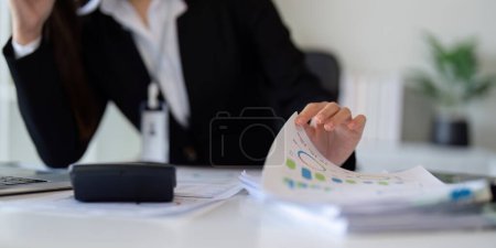 Photo for Business accounting woman counting on calculator working on financial document in hands closeup. Bookkeeping concept. - Royalty Free Image