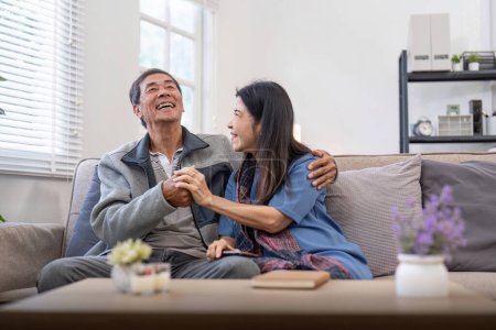 Photo for Happy mature husband and wife sit rest on comfortable sofa in living room enjoy talking, smiling elderly couple relax on couch at home chat speak laugh on leisure weekend. - Royalty Free Image