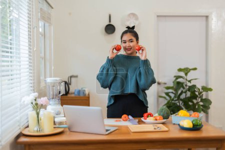 Photo for Fat woman cooking in kitchen. health care concept Eat health food to lose weight. Learn to make salads and healthy food from online. - Royalty Free Image