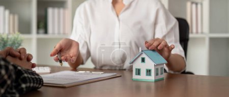 Photo for Customer meet and negotiation with real estate agents about renting, buying home, Real estate agent negotiate, talk about the terms of the home purchase agreement and asked customer to sign contract. - Royalty Free Image