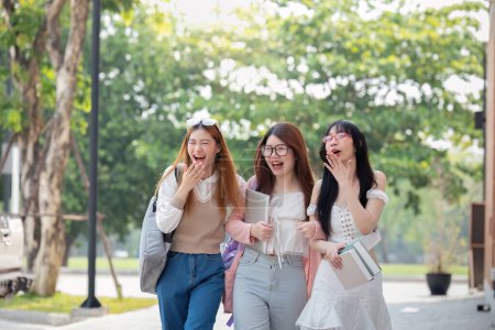 Photo for College friends walk to class together. University student in campus talk and have fun outdoors. - Royalty Free Image