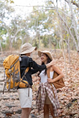 Photo for Happy LGBT lesbian couple travel enjoy hiking with backpack in forest trail. - Royalty Free Image