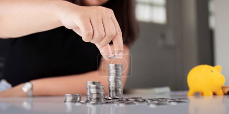 Photo for Young Asian woman making stack of coin. invest save finance concept, saving money, investment. - Royalty Free Image