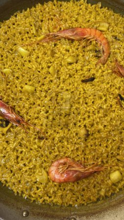 Photo for Valencian paella. Valencian-style rice with prawns. Spanish homemade food. Mediterranean food - Royalty Free Image