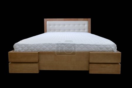 Foto de Double wooden bed with a mattress on a transparent background, cut out - Imagen libre de derechos