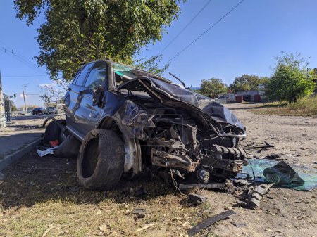 Photo for Car accident on a city highway. A wrecked car beyond repair thrown on the side of the road - Royalty Free Image