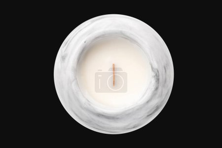 scented candle with a wooden wick in a plaster candlestick, top view on isolated background