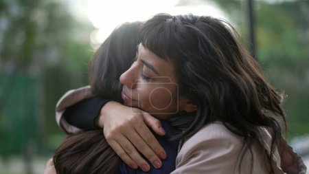 Téléchargez les photos : Sympathetic woman hugging friend with EMPATHY and SUPPORT. Friendship concept between two best friends - en image libre de droit
