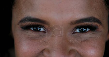 Photo for African girl close-up eyes looking at camera, mixed race woman closing and opening eyes - Royalty Free Image
