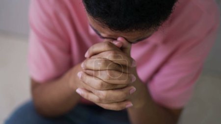Photo for Hopeful young man in prayer. Closeup person hands praying to God. Spiritual and religious individual having FAITH - Royalty Free Image