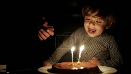 Photo for Happy baby blowing birthday candles. two years old celebration - Royalty Free Image