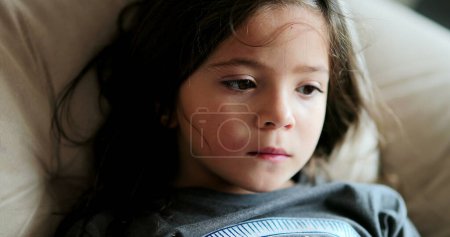 Photo for One pensive little girl portrait face looking sideways feeling preoccupied - Royalty Free Image