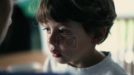 Photo for Candid tearful small boy listening to mother scold him for misbehaving. Closeup sad child face learning lesson. Parent education concept. Kid head nod. Child nodding - Royalty Free Image