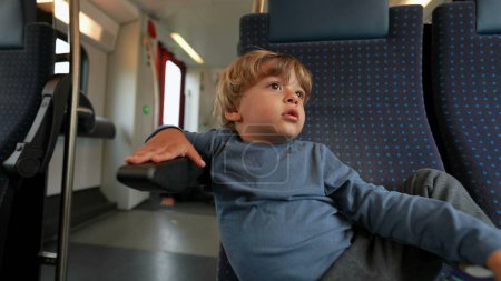 Photo for One bored child sitting on train traveling kid in boredom - Royalty Free Image