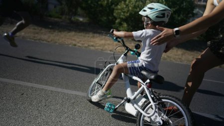 Photo for Child falling from bicycle while learning to ride. Small boy falls from bike - Royalty Free Image
