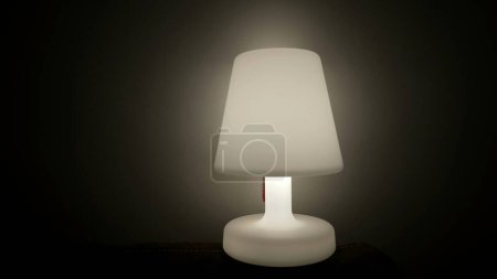 Photo for One Lamp glowing light in dark. Bedside nightlamp - Royalty Free Image